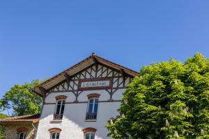 a building with a sign on top of it at Best Western Plus Paris Meudon Ermitage in Meudon