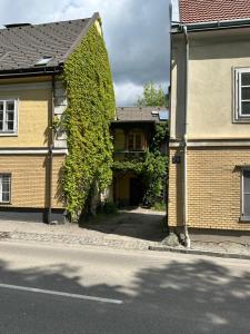 a house with a green ivy growing on the side of it at Ferienwohnung in Reichenau an der Rax in Reichenau +3 photos