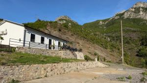 a house on the side of a mountain at Xhoen guesthouse in Shkodër +29 photos