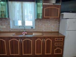 a kitchen with a sink and a white refrigerator at Studios Florand Sela Ksamil in Ksamil +158 photos