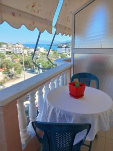 a table on a balcony with a view of the ocean at Studios Florand Sela Ksamil in Ksamil