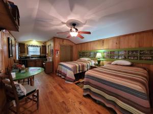 a hotel room with two beds and a ceiling fan at FireFly Acres in Sparta +29 photos