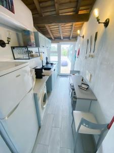 a kitchen with a white refrigerator and a stove at A Casinha in Portel