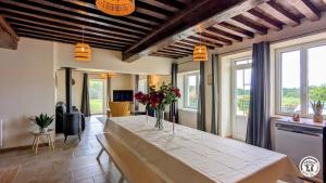 a living room with a table with flowers on it at Clos de Vellerot in Saint-Pierre-en-Vaux
