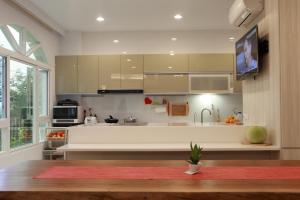 a large kitchen with a large white counter top at Gancheng 35 in Jian