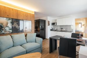 a living room and kitchen with a couch and a table at Aparthotel Viktorias Home in Kufstein