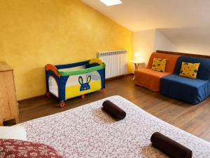 a room with a play room with a bed and a couch at Apartamentos Saltarel·lo in Besalú +24 photos