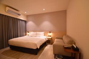 a hotel room with a bed and a chair at Cheng House in Yuchi