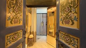 a hallway with a door and a mirror on the wall at Karawan Riad in Fez +30 photos