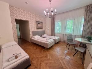 a living room with two beds and a table at KUBU namai in Klaipėda