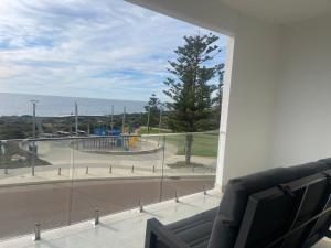 a living room with a view of a playground from a window at Coastal Calm Seascapes unit 2 in Falcon