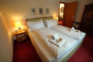 a hotel room with a bed with towels on it at Chalet Miravalle 1 in Wengen