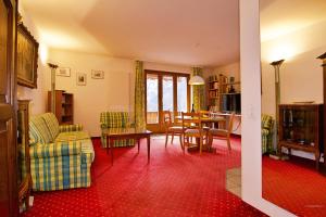 a living room with a couch and a table and chairs at Chalet Miravalle 1 in Wengen