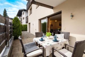 a table and chairs on the patio of a house at Sonnplatzl Appartement Westendorf in Westendorf +22 photos