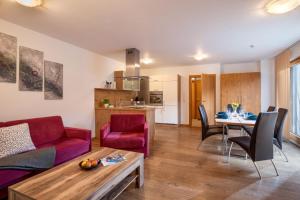 a living room with a couch and a table at Sonnplatzl Appartement Westendorf in Westendorf