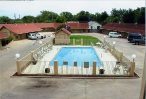 a large swimming pool in a parking lot at Will Rogers Inn in Claremore