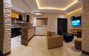 a kitchen and living room with a bar and a couch at Citistay Apartments in Abuja