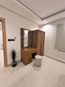 a room with a wooden cabinet and a potted plant at ايراد للشقق المفروشه in Dammam