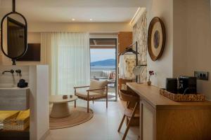 a kitchen and living room with a view of the ocean at Kelyfos Nafpaktos in Nafpaktos