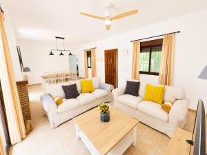 a living room with two couches and a table at Casa el Jilguero Conil in Conil de la Frontera +27 photos