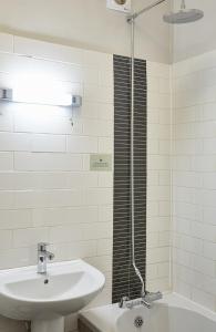 a white bathroom with a sink and a shower at Sun Inn in Eastwood +29 photos