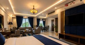 a hotel room with a bed and a living room at Envoy Continental Hotel, Blue Area, Islamabad in Islamabad