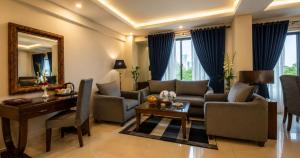 a living room with a couch and a table at Envoy Continental Hotel, Blue Area, Islamabad in Islamabad