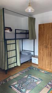 a room with two bunk beds and a rug at Kardelen Hostel in Prishtinë