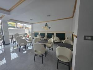 a restaurant with tables and chairs in a room at Goldsip lounge in Addis Ababa