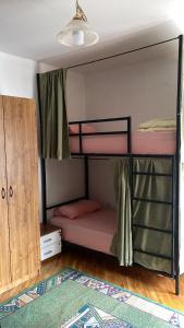 a bedroom with two bunk beds and a closet at Kardelen Hostel in Prishtinë +25 photos