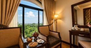 a hotel room with a table with a bowl of fruit on it at Envoy Continental Hotel, Blue Area, Islamabad in Islamabad