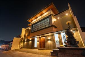 a large building with lights on it at night at Dekade Living in Denpasar