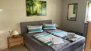 a bed with two pillows on it in a bedroom at Ferienwohnung Panoramablick in Bolsterlang