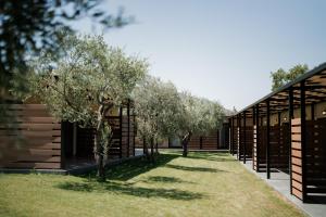a row of trees in front of a building at Meraki luxury bungalows in Rakhónion