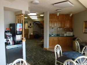 a kitchen and dining room with a refrigerator and chairs at Wilmington Inn in Wilmington