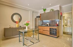 a kitchen with a glass table and a counter at Irene Luxury Suite Roda in Roda