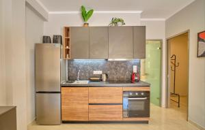 a kitchen with a stainless steel refrigerator at Irene Luxury Suite Roda in Roda +13 photos