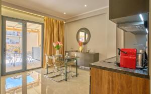 a kitchen with a counter and a table with a red appliance at Irene Luxury Suite Roda in Roda
