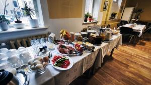 a long table with plates of food on it at Hostel Lõuna in Pärnu