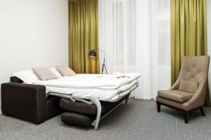 a bedroom with a bed and a chair at Elite Hotel Ideon, Lund in Lund +111 photos