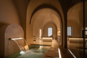 a bathroom with a plunge pool in a building at Patria Palace Lecce - The Leading Hotels of The World in Lecce +71 photos