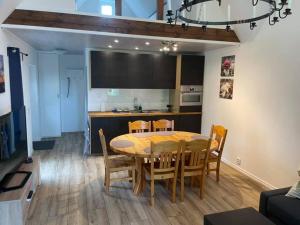 a dining room and kitchen with a table and chairs at Charmig stuga i Abbekås in Abbekås