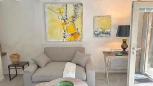 a living room with a couch and a table at Le Refuge in Denicé