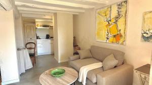 a living room with a couch and a table at Le Refuge in Denicé
