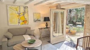 a living room with a couch and a table at Le Refuge in Denicé