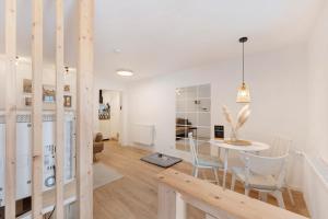 a dining room and living room with a table and chairs at Ferienwohnung Tromei-Hof in Oberderdingen
