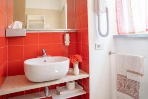 a bathroom with a white sink and a mirror at Villa Paggi Country House in Carasco +49 photos