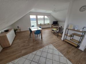 a large living room with a table and chairs at FeWo Weitblick in Sassenburg