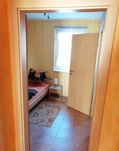 a room with a bed and a window and a door at Ferienhaus B2 Concordiasee in Friedrichsaue
