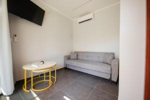 a living room with a couch and a table at Meraki luxury bungalows in Rakhónion
